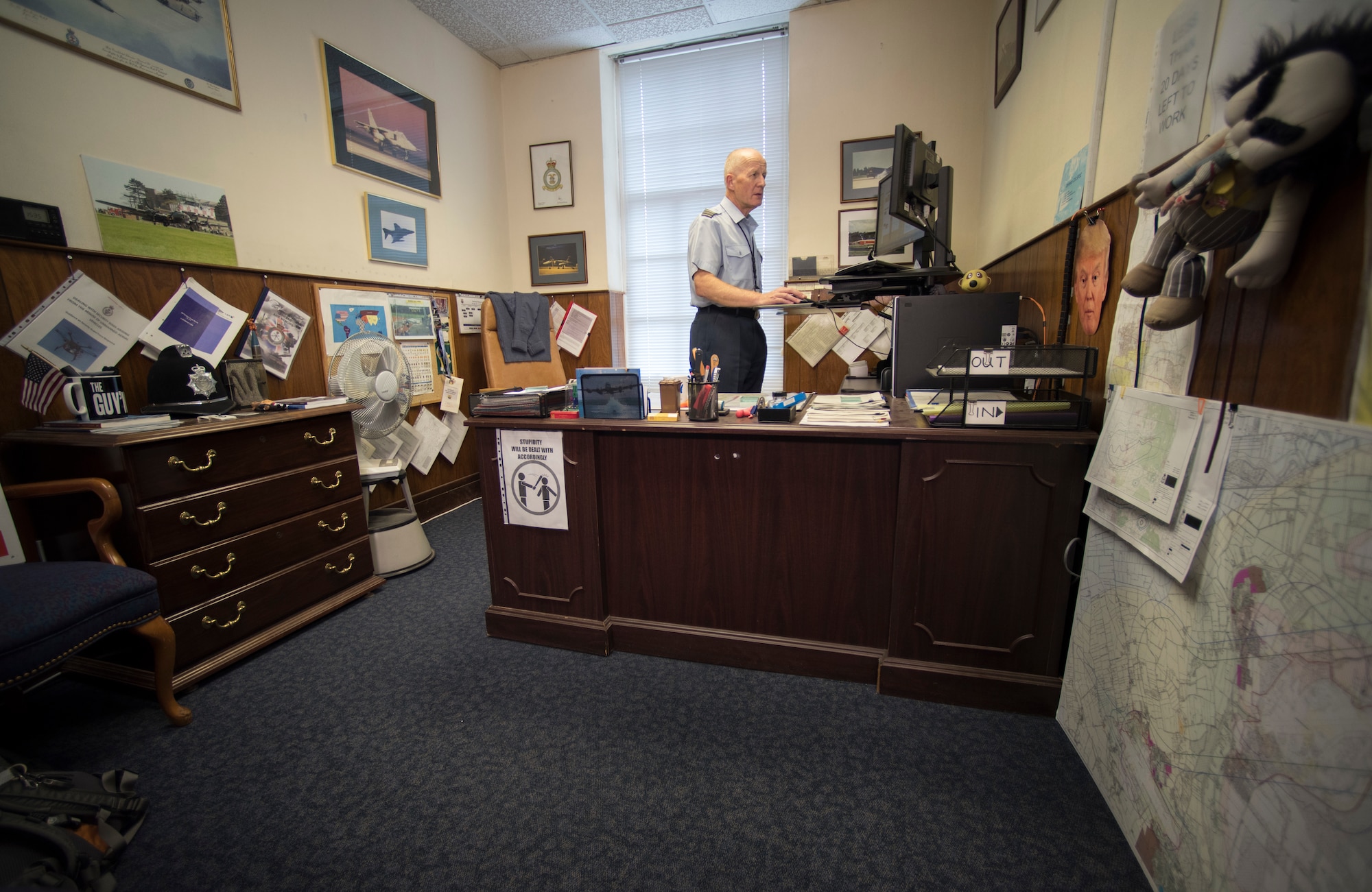 Royal Air Force Sqn. Ldr. Richard Fryer, RAF Mildenhall station commander, completes tasks in his office at RAF Mildenhall, England, July 31, 2018. Fryer’s primary duty was an air traffic controller before his role as station commander at RAF Mildenhall from 2007 to 2018. (U.S. Air Force photo by Senior Airman Kelly O’Connor)
