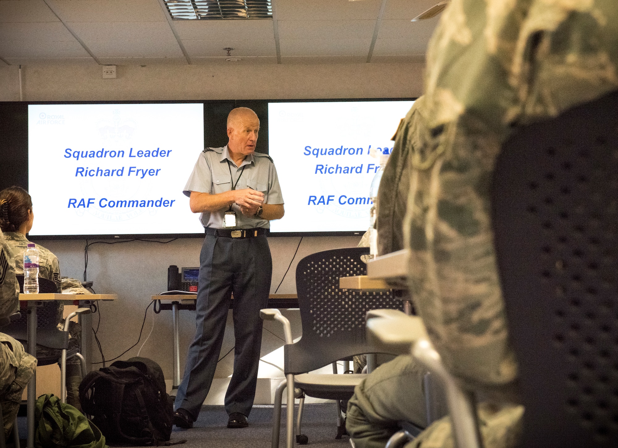Royal Air Force Sqn. Ldr. Richard Fryer, RAF Mildenhall station commander, welcomes newcomers to the base at the Airman Family and Readiness Center at RAF Mildenhall, England, Aug. 7, 2018. The briefing was one of the last Fryer gave to Mildenhall newcomers before his retirement. (U.S. Air Force photo by Senior Airman Kelly O’Connor)