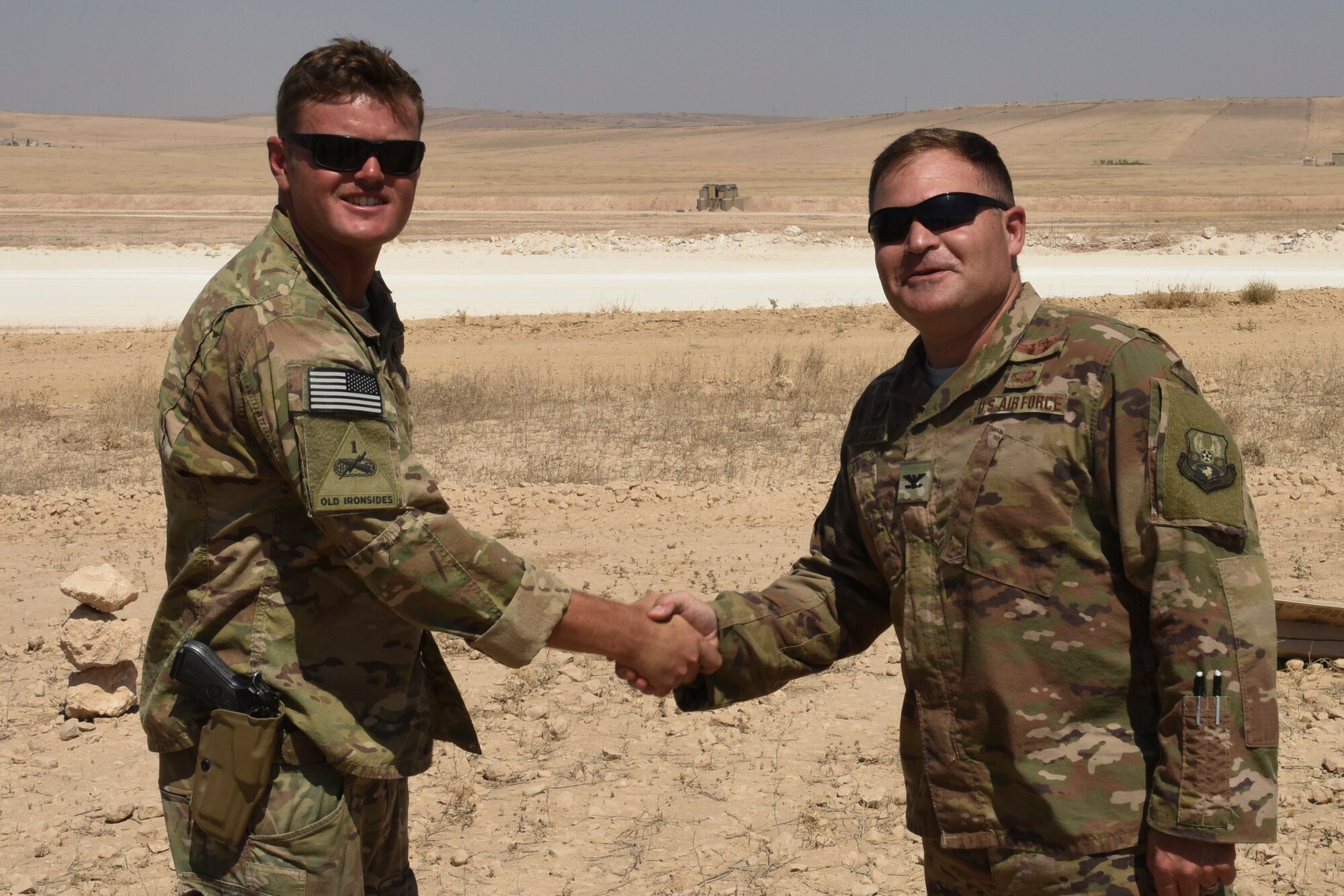 Col. Patrick Schlichenmeyer, 386th Air Expeditionary Wing commander, recognizes Tech. Sgt. Robert Powell, 441st Air Expeditionary Squadron Explosive Ordnance Disposal team lead, for being selected as the Rock Solid Warrior Aug. 17, 2018, at an undisclosed location in Southwest Asia. The Rock Solid Warrior program recognizes Airmen across the wing for their contribution to the mission. (U.S. Air Force photo by Tech. Sgt. Caleb Pierce)