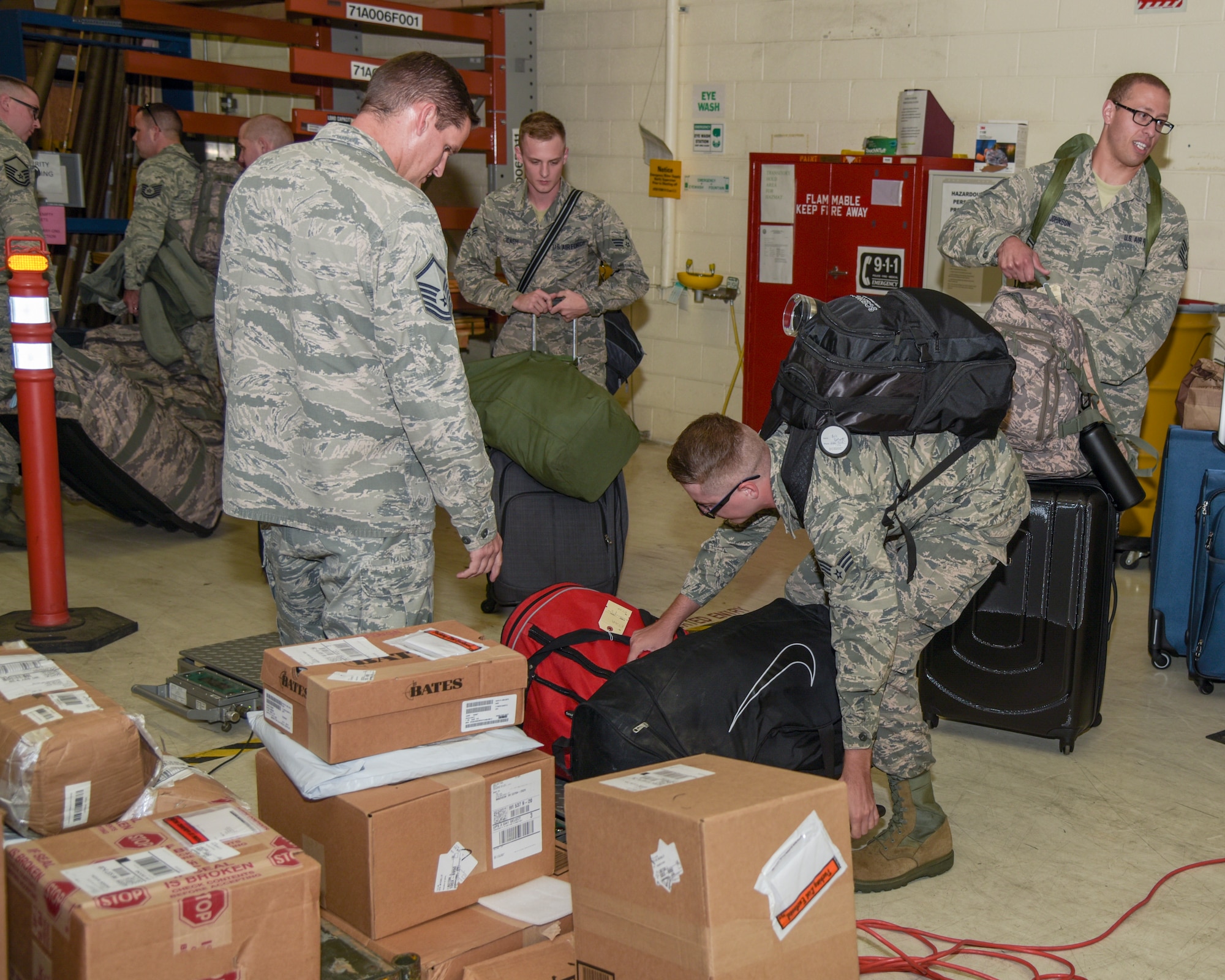 Master Sgt. RN, JTU, weighs Airmen’s bags August 29, 2018, in the deployment proccessing center at the 115th Fighter Wing, Truax Field, Wisconsin. Approximately 30 Airmen with the 115th Force Support Squadron are going TDY to Ramstein Air Base, Germany.(U.S. Air National Guard photo by Airman 1st Class Cameron Lewis)