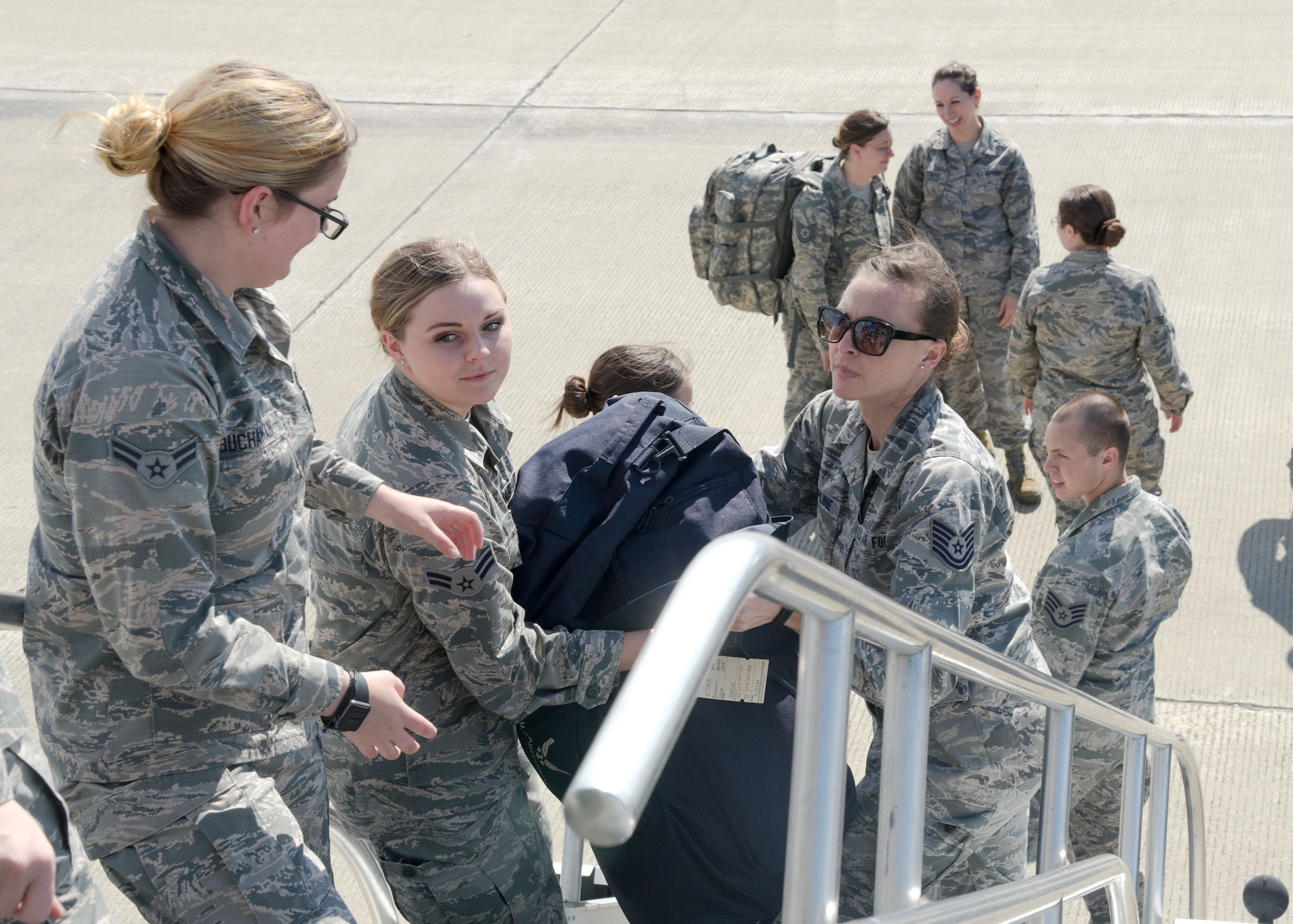 Airman 1st Class Tiana Buchanan, Airman 1st Class Lauren Ludka, and Tech. Sgt. Angela Krepline, all with the 115th Force Support Squadron, Truax Field, Wisconsin, load bags onto a KC-135 Stratotanker, assigned to the 128th Air Refueling Wing, General Mitchell Air National Guard Base, Wisconsin, before departing from Truax Field to Ramstein Air Base, Germany Aug. 29, 2018. The 115th FSS is going TDY to Ramstein for approximately two-weeks as part of a movement for training mission. (U.S. Air National Guard photo by Airman 1st Class Cameron Lewis)
