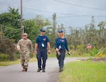 Staff Sgt. William Muira, from the Hawaii National Guard's CBRNE Enhanced Response Force Package (CERFP) Team, escorts FEMA Urban Search and Rescue members from California Task Force 3 while they perform a wide-area assessment in the wake of Hurricane Lane in Kea'au, Hawaii, on Aug. 27, 2018.