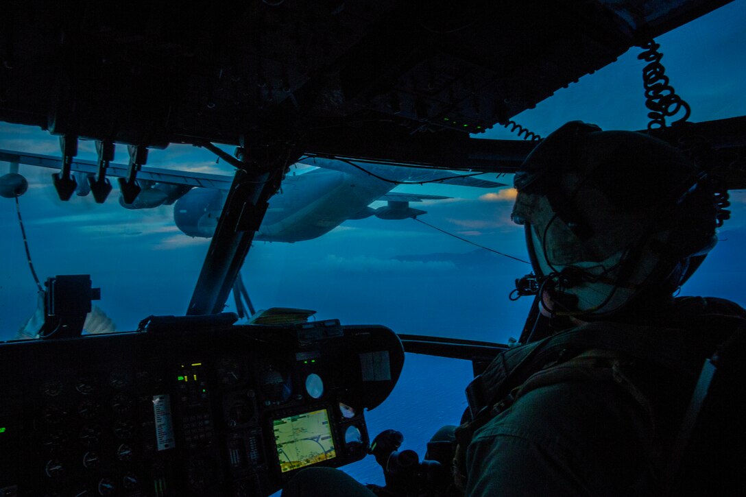 A U.S. Marine CH-53E Super Stallion Helicopter pilot with Special Purpose Marine Air-Ground Task Force - Southern Command keeps the helicopter steady as he conducts an aerial refueling over the Caribbean Sea off the coast of Honduras, Aug. 28, 2018. The Marines and sailors of SPMAGTF-SC are conducting security cooperation training and engineering projects alongside partner nation military forces in Central and South America. The unit is also on standby to provide humanitarian assistance and disaster relief in the event of a hurricane or other emergency in the region.