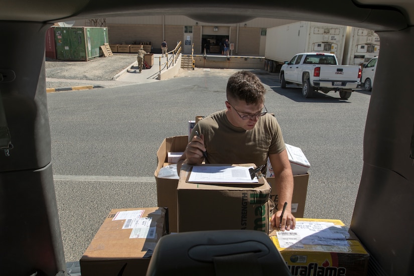 U.S. Army Spc. James Day, a human resources specialist with the 151st Regional Support Group, Massachusetts Army National Guard, attached to U.S. Army Central, marks packages with sorting codes before transporting them from the main post office to the USARCENT mail room at Camp Arifjan, Kuwait, Aug. 20, 2018. Consistent mail delivery in a deployed environment is a critical capability for overseas units.