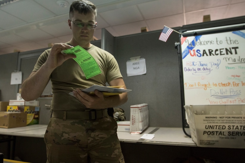 U.S. Army Spc. James Day, a human resources specialist with the 151st Regional Support Group, Massachusetts Army National Guard, attached to U.S. Army Central, searches through a stack of letters for anything belonging to a visitor to the USARCENT mail room at Camp Arifjan, Kuwait, Aug. 20, 2018. Providing convenient mail service to deployed Soldiers promotes morale and cohesion within units.