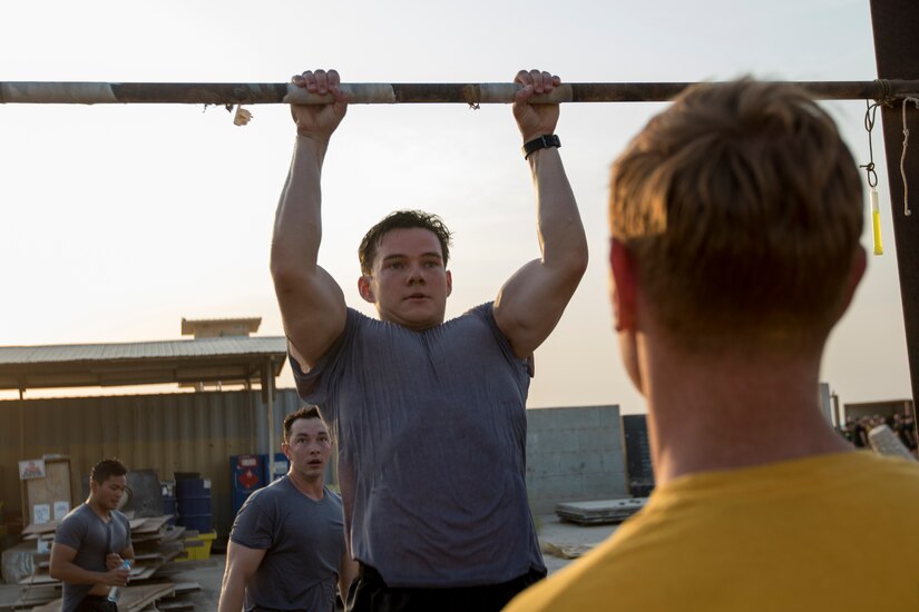 A U.S. Army Soldier raises his body during the pull up event of the 74th Engineer Dive Detachment's Diver Fitness Challenge at Kuwait Naval Base, Kuwait, Aug. 31, 2018. The competition offered an opportunity for Soldiers from many different units to test their abilities against each other with challenges many of the Soldiers had never faced before.