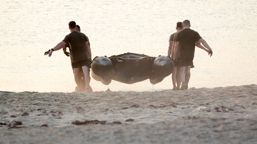A team of U.S. Army Soldiers carry a Zodiac rigid inflatable boat during one of the events of the 74th Engineer Dive Detachment's Diver Fitness Challenge at Kuwait Naval Base, Kuwait, Aug. 31, 2018. The events of the Diver Fitness Challenge are not exercises typically done by Soldiers in the U.S. Army, so they provide a unique opportunity for Soldiers to increase their capabilities by trying new challenges.