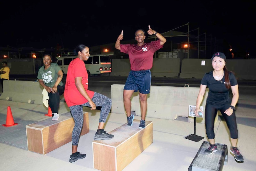 U.S. Army Command Sgt. Maj. Cynthia Reed of Area Support Group-Qatar gives a smile and thumbs-up at the Sisters in Arms circuit training event at Camp As-Sayliyah, Qatar, August 23, 2018.