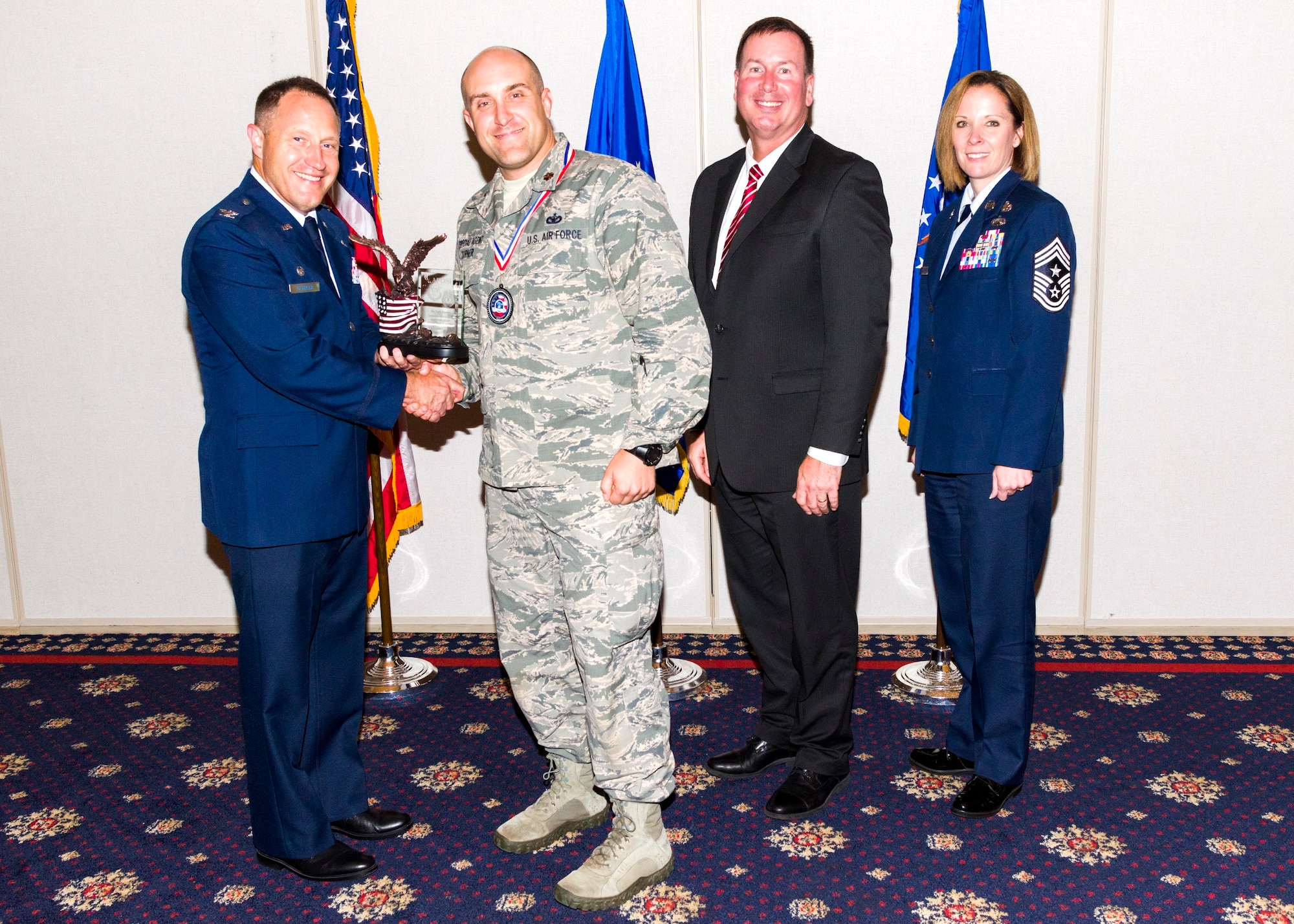 Maj. TJ Turner was recently awarded the Air Force Office of Special Investigations Individual Mobilization Augmentee of the year award. Pictured left to right are Col. Kirk Stabler, Commander, AFOSI, Maj. TJ Turner, Mr. Jeffrey Specht, Executive Director, AFOSI and Chief Master Sgt. Karen Beirne Flint, Command Chief, AFOSI. (U.S. Air Force courtesy photo)