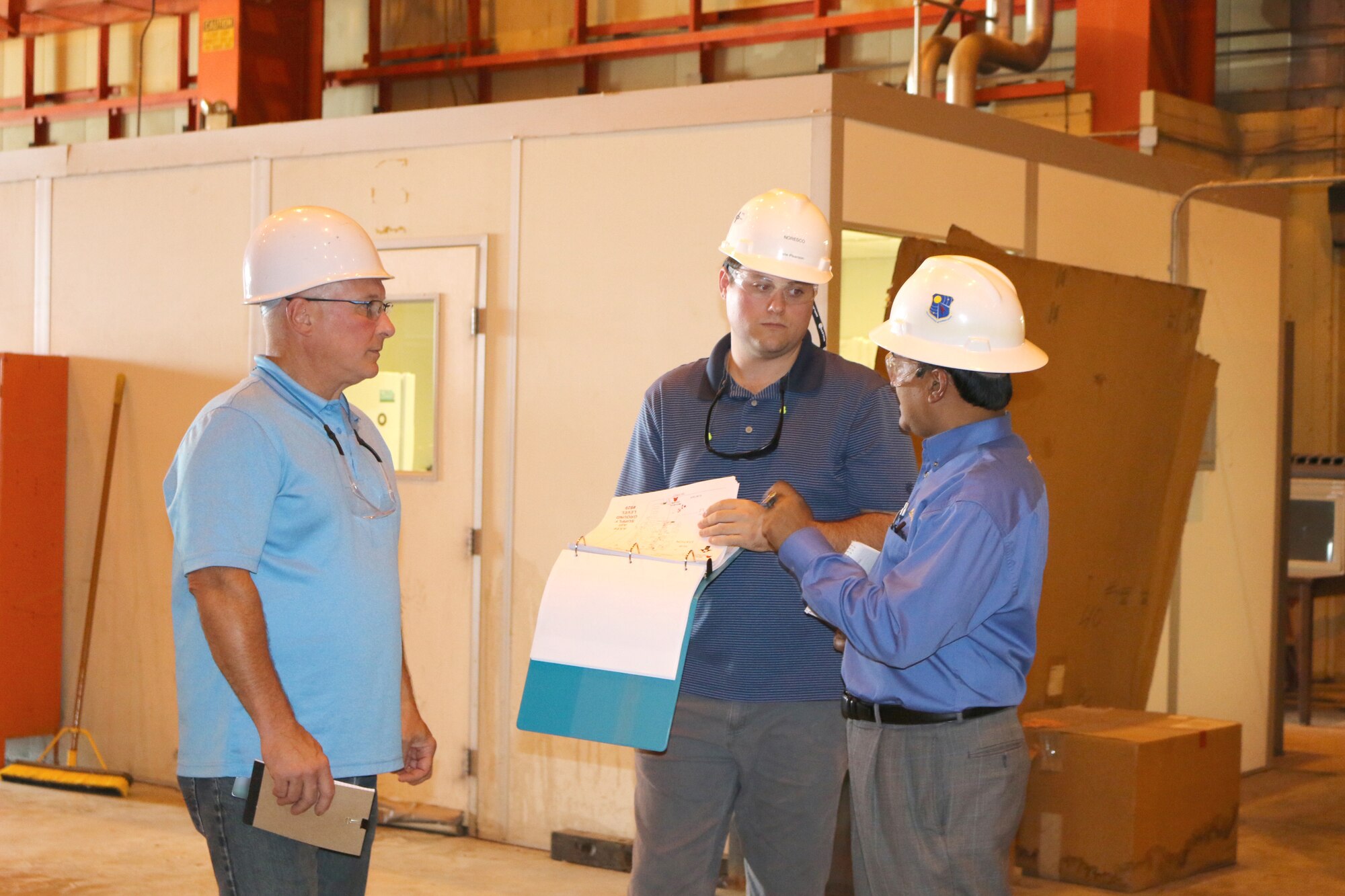Kazi Mamun, Arnold Resource Efficiency Manager, at right, speaks with two representatives with NORESCO, a Super Energy Savings Performance Contractor, during a recent walkthrough of facilities at Arnold Air Force Base. NORESCO recently received a $19.7 million energy savings performance contract award to perform work at Arnold through the Air Force Civil Engineering Center and Defense Logistics Agency. (U.S. Air Force photo by Deidre Ortiz)