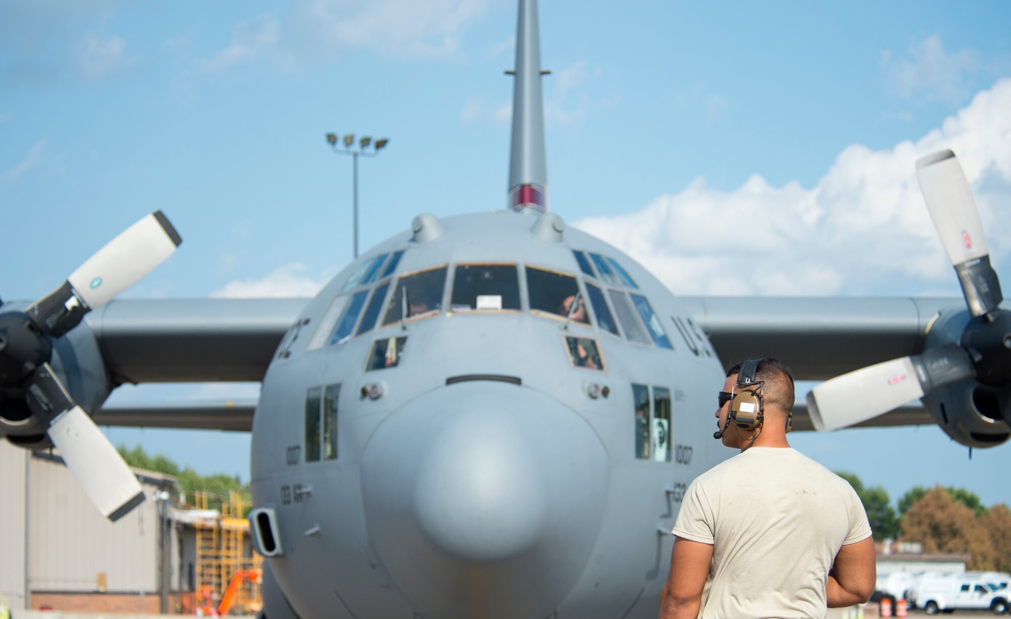 U.S. Air Force Staff Sgt. Taylor Priebe, a crew chief with the 133rd Aircraft Maintenance Squadron, helps the aircrew with their pre-flight checks in St. Paul, Minn., Aug. 8, 2018.