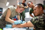 daho Army National Guard Sgt. Mikki Fritz, a combat medic, gives a medic from the Thai army an IV as part of medical training during the Hanuman Guardian 2018 exercise at the Cavalry Center in Saraburi province, Thailand.