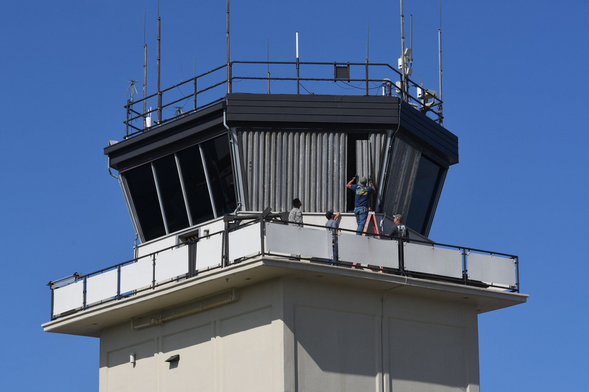 Keesler personnel board up the windows surrounding the air traffic control tower on Keesler Air Force Base, Mississippi, Sept. 4, 2018. Safety measures are being taken around the base to prepare for the arrival of Hurricane Gordon to the Gulf Coast Sept. 4. (U.S. Air Force photo by Kemberly Groue)