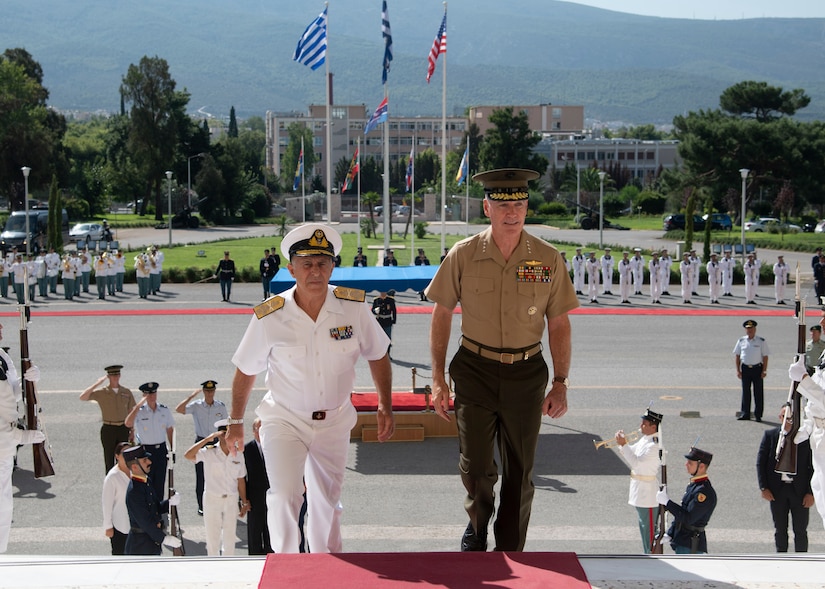 Marine Corps Gen. Joe Dunford, chairman of the Joint Chiefs of Staff, and Greek navy Adm. Evangelos Apostolakis, chief of the Hellenic National Defense General Staff, walk into the Greek defense ministry in Athens following a welcome ceremony.