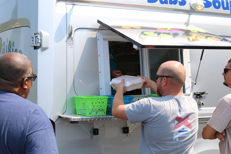 An AEDC team member receives his order from the Crazy Daisies food truck during its first day of operations at Arnold Air Force Base. The food truck, which is located in the parking lot of the Main Auditorium, began business at Arnold on Aug. 14. (U.S. Air Force photo by Bradley Hicks)