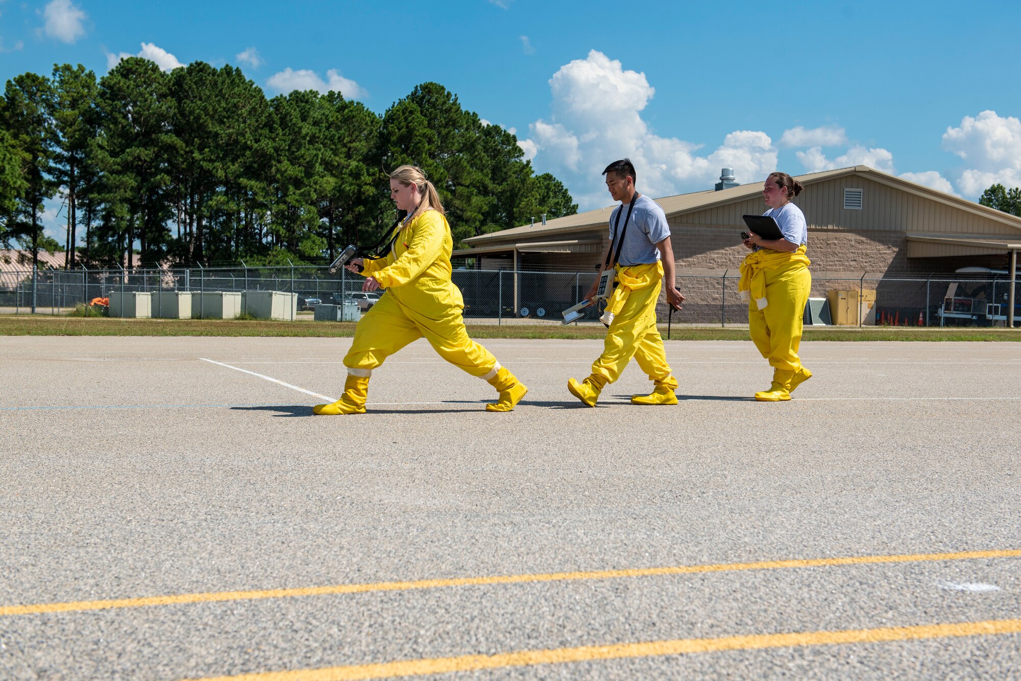 A joint team comprised of U.S. Airmen from the 20th Civil Engineer Squadron emergency management flight and the 20th Aerospace Medicine Squadron bioenvironmental engineering flight walk in a straight line while searching for simulated radiation for an exercise survey at Shaw Air Force Base, S.C., Aug. 29, 2018.