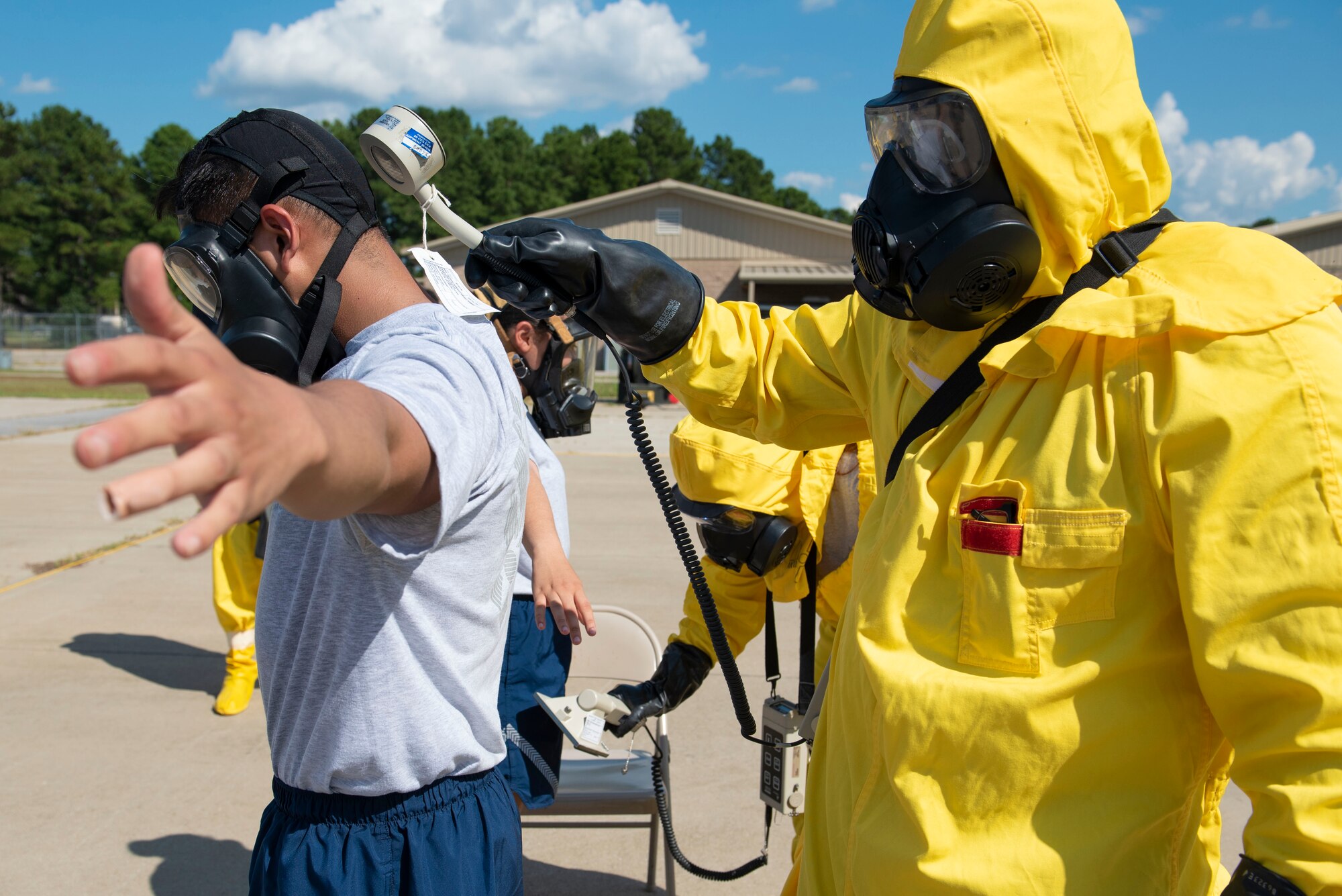 U.S. Airmen scan individuals going through a decontamination line for simulated radiation during a joint response training at Shaw Air Force Base, S.C., Aug. 29, 2018.