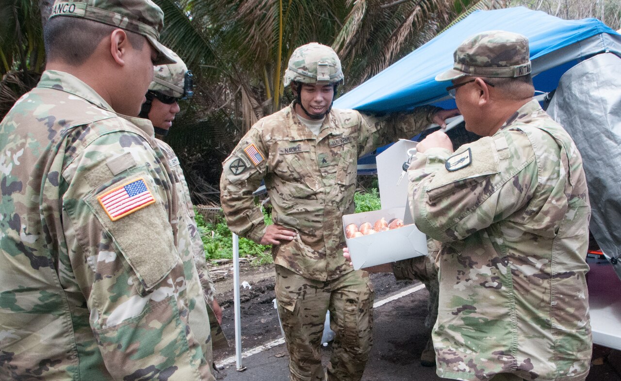 Hawaii Army National Guard Chaplain (Maj.) Ray Kitagawa brings doughnuts to service members manning security checkpoints in Pahoa, Hawaii as part of a morale check.