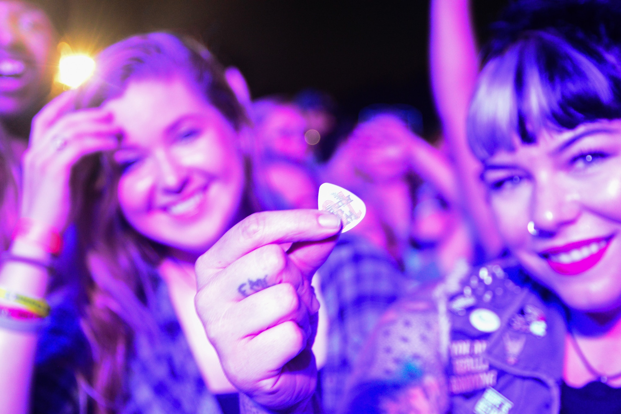 Logan Hall shows off the guitar pick she caught during the End of Summer Music Festival performance Sept. 2, 2018, at Dover Air Force Base, Del. The opportunity to host a concert involving rock bands We the Kings and X Ambassadors came through Air Force Entertainment. (U.S. Air Force photo by Airman 1st Class Dedan Dials)