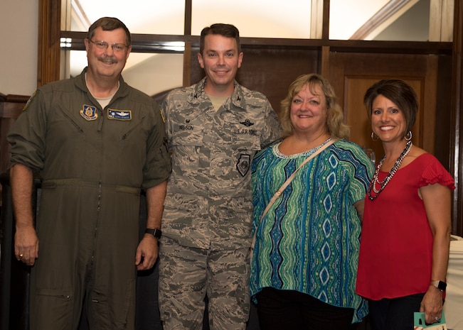 Col. Jeff Nelson, second from left, 628th Air Base Wing commander, and his wife Courtney, right, thank Col. Gregory Gilmour, left, 315th Airlift Wing commander and his wife Kathy for a farewell gift during Nelson’s going away ceremony Sept. 4, 2018 at the Joint Base Charleston Club.