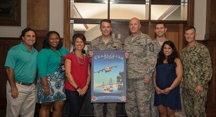 Col. Jeff Nelson, center, 628th Air Base Wing commander, and his wife Courtney accept a gift from the 628th ABW front office during his going away ceremony Sept. 4, 2018 at the Joint Base Charleston Club.