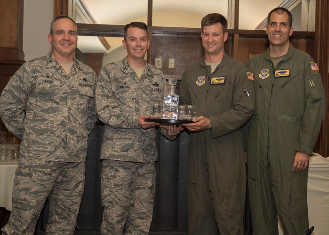 Col. Jeff Nelson, left center, 628th Air Base Wing commander, receives a farewell gift from Col. Mark Harris, left, 437th Maintenance Group commander, Col. Clint ZumBrunnen, 437th Airlift Wing commander, and Col. Dan Dobbels, 437th Operations Group commander during his going away ceremony Sept. 4, 2018 at the Joint Base  Charleston Club.
