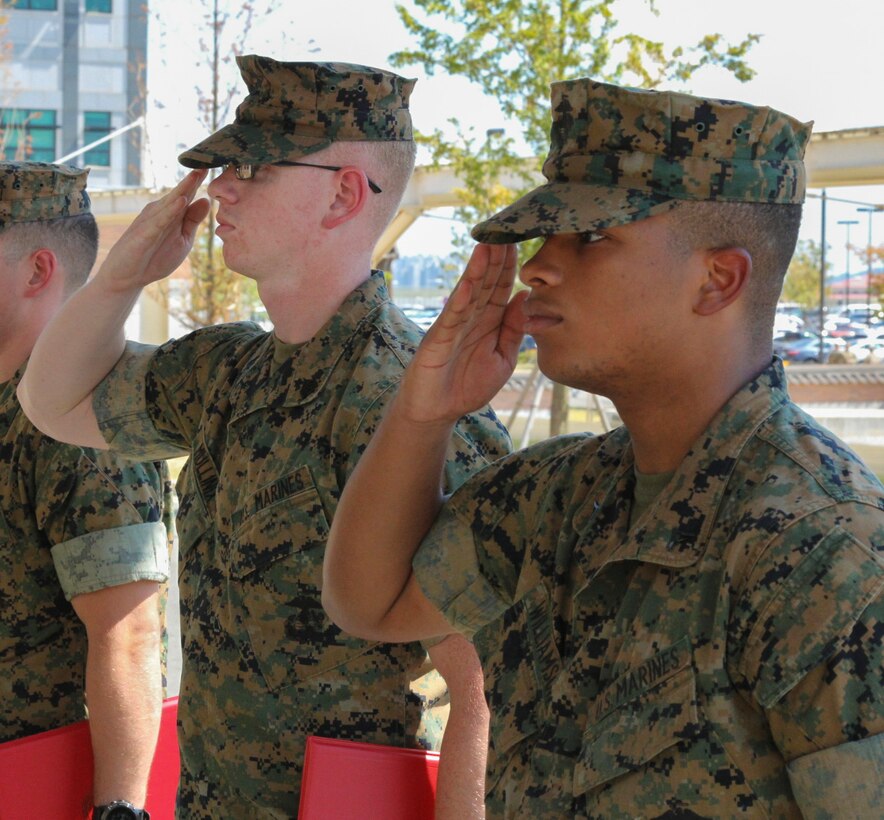 CAMP HUMPHREYS, Republic of Korea –Sgt. Tyler Mullinix (left), G6 helpdesk NCO-in-charge, and Lance Cpl. Elijah Williamson (right), G3 force protection plans and execution clerk, receive a Certificate of Commendation after winning the Non-Commissioned Officer and Marine of the Quarter board, here, Aug. 17.  MARFORK recognized the Marines for their significant contributions to mission accomplishment while setting an excellent example for their peers to emulate. (U.S. Marine Corps photo by Sgt. Nathaniel Hanscom/Released)