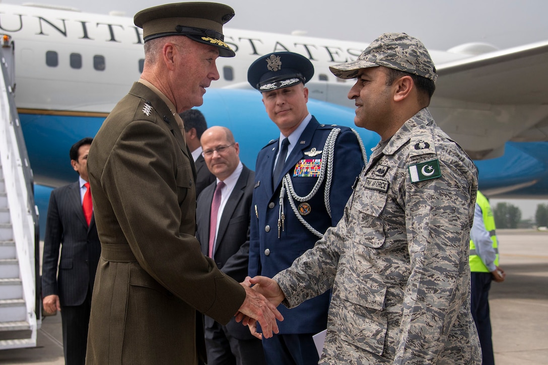 Marine Corps Gen. Joe Dunford, chairman of the Joint Chiefs of Staff, shakes hands with a Pakistani military official.