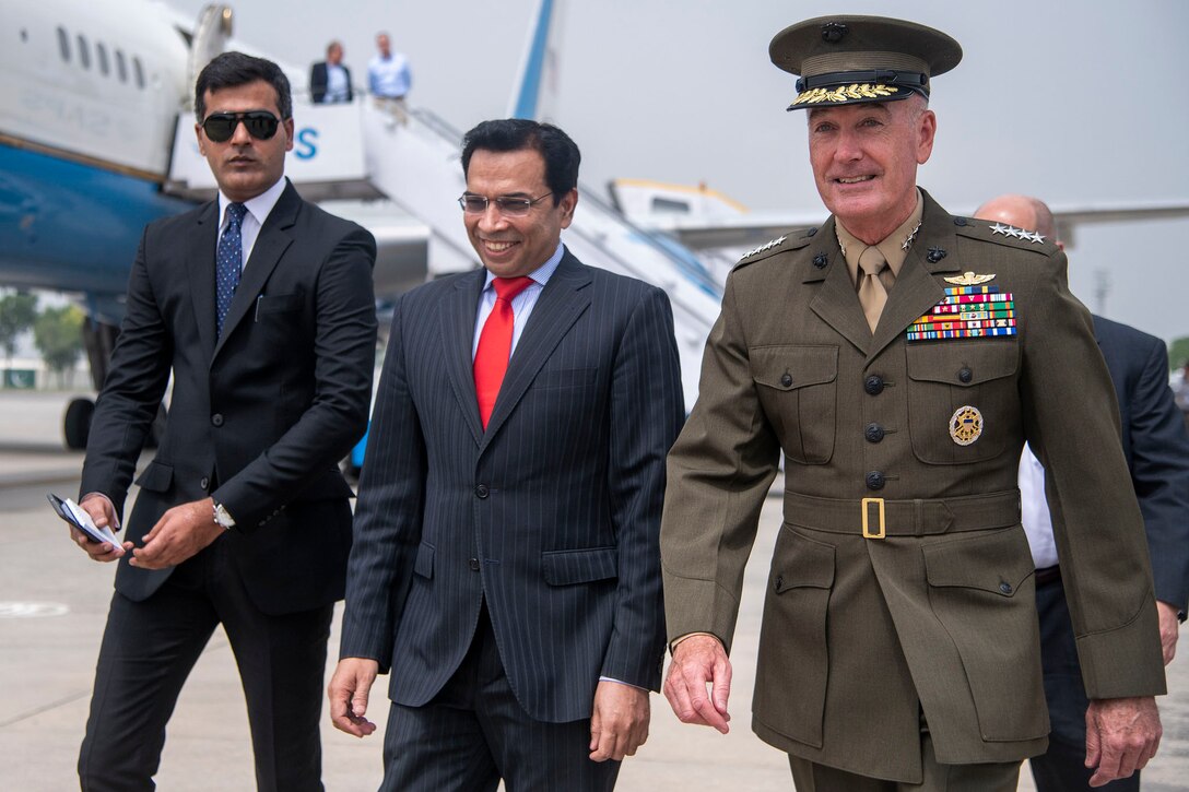 Marine Corps Gen. Joe Dunford, chairman of the Joint Chiefs of Staff, walks with Pakistani officials after arriving in Islamabad.