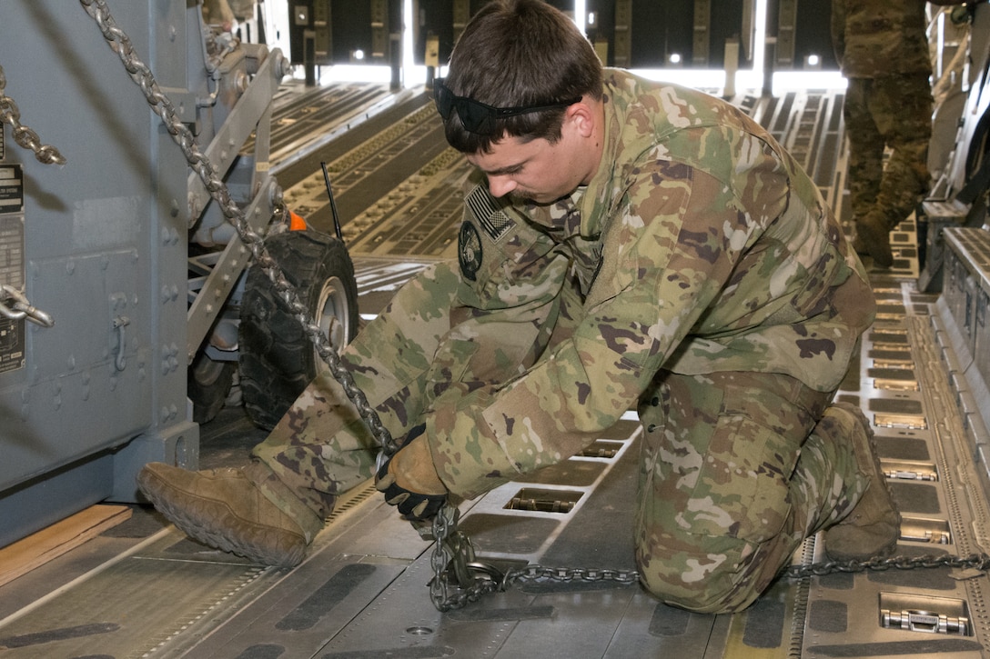 Staff Sgt. Davin Losack, 816th Expeditionary Airlift Squadron, secures a mobile shelter being transported between U.S. Africa Command and U.S. Central Command onboard a C-17 Globemaster III prior to departure from Camp Lemonnier, Djibouti, Aug. 28, 2018. Al Udeid-based aircraft have completed nearly 15 missions this calendar year between the two commands. (U.S. Air Force photo by Tech. Sgt. Ted Nichols/Released)