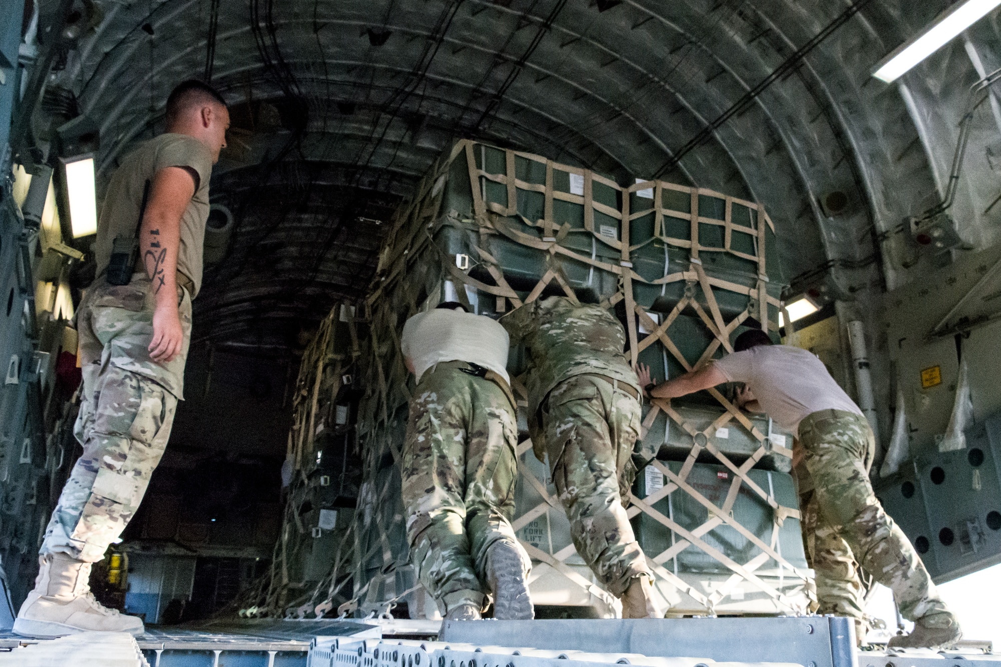 Personnel from the 816th Expeditionary Airlift Squadron and 332nd Air Expeditionary Wing load cargo on a C-17 Globemaster III at an undisclosed location in Southwest Asia after transporting cargo between U.S. Africa Command and U.S. Central Command, Aug. 28, 2018. Al Udeid-based aircraft have completed nearly 15 missions this calendar year between the two commands. (U.S. Air Force photo by Tech. Sgt. Ted Nichols/Released)