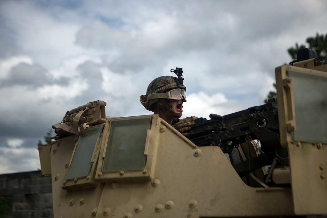 Marines fires an M240B machine gun during military operations in urban terrain training.