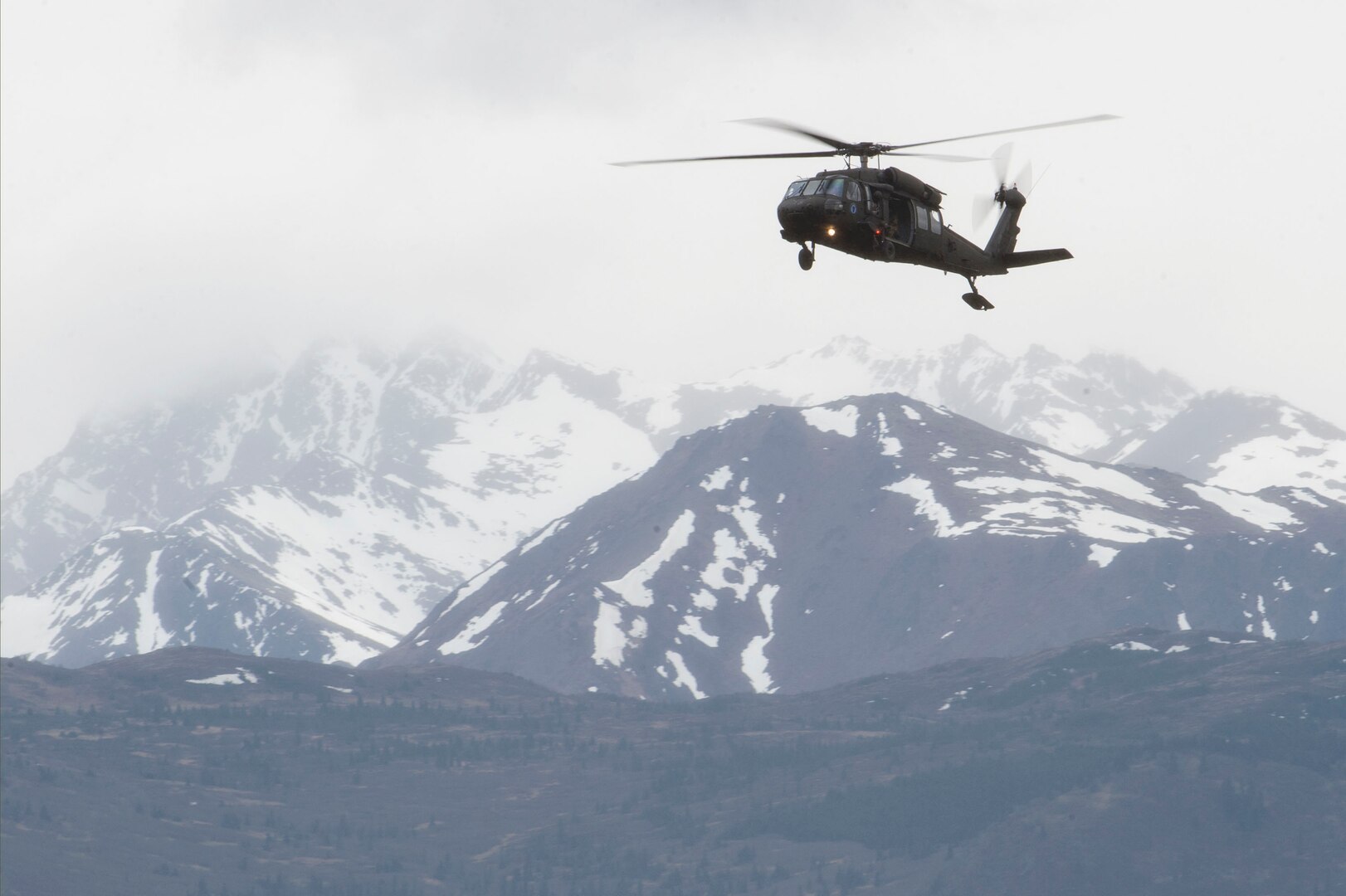 An Alaska Army National Guard UH-60 Black Hawk helicopter approaches Malemute Drop Zone during airborne training at Joint Base Elmendorf-Richardson, Alaska, May 30, 2018. A similar aircraft rescued three people near St. Mary's after a plane crash on Sept. 3, 2018.