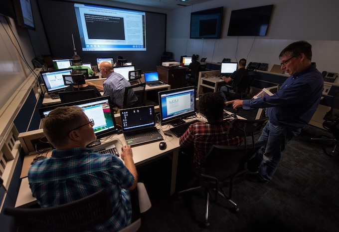 Space and Naval Warfare Systems Center (SSC) Atlantic employee Fred Bisel, a scientist and Cisco Academy expert instructor teaches students in the Cyber Education and Certification Readiness Facility (CERF) Lab.