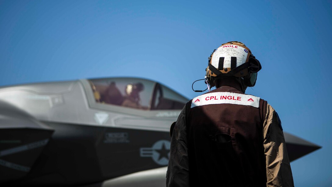 U.S. Marine Cpl. Travis Ingle, a plane captain with Marine Fighter Attack Squadron 211, 13th Marine Expeditionary Unit prepares an F-35B Lightning II for take-off aboard the Wasp-class amphibious assault ship USS Essex, September 3, 2018.  The Essex is the flagship for the Essex Amphibious Ready Group and, with the embarked 13th MEU, is deployed to the U.S. 5th Fleet area of operations in support of naval operations to ensure maritime stability and security in the Central Region, connecting the Mediterranean and the Pacific through the western Indian Ocean and three strategic choke points.