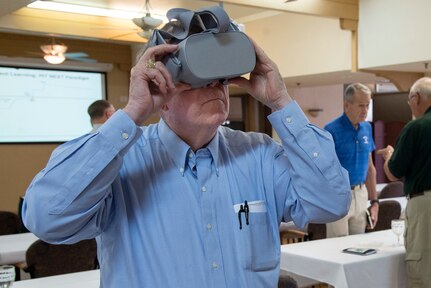 One of more than 40 veteran Air Force aviators tries on a set of virtual reality goggles Aug. 27, 2018 at the Parr Club on Joint Base San Antonio-Randolph, Texas.