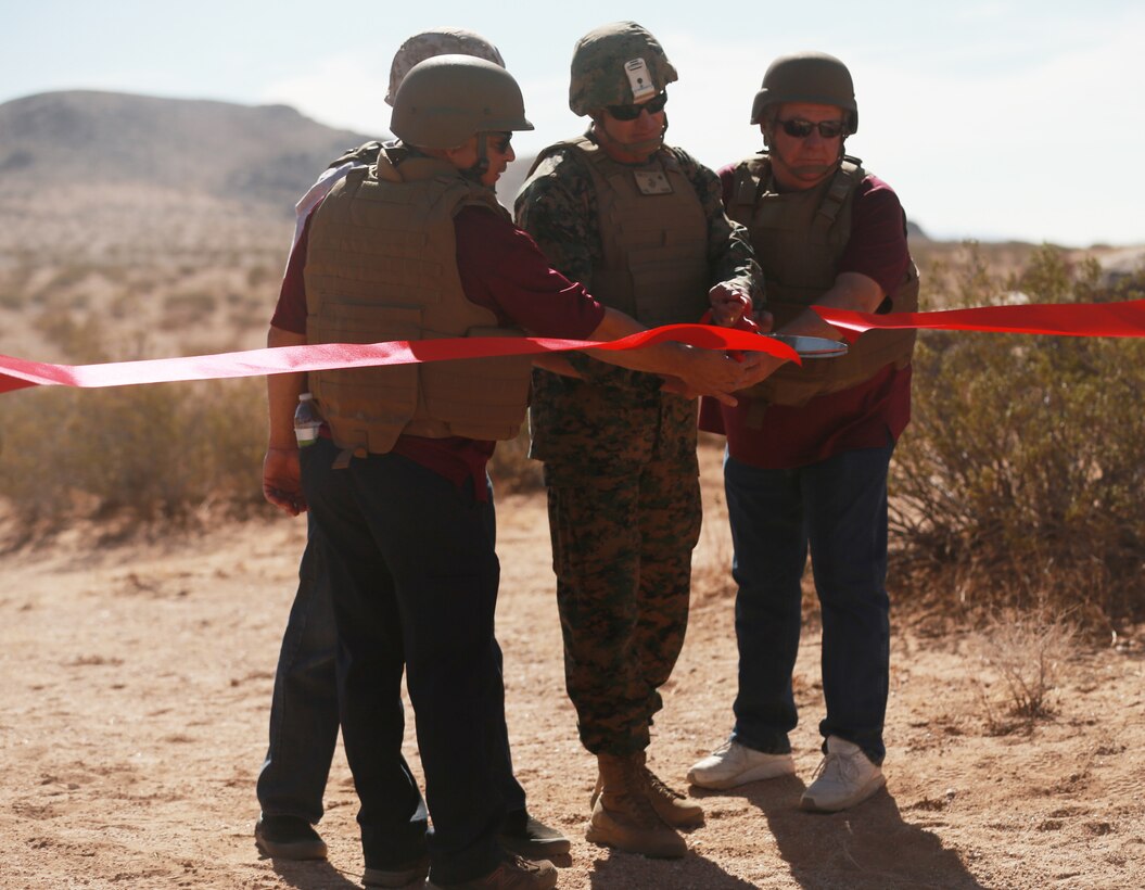 Brig. Gen. Roger Turner, Combat Center Commanding General, cuts the ribbon during the ribbon cutting ceremony and live-fire demonstrations of the newly opened Johnson Valley Exclusive Military Use Area aboard the Marine Corps Air Ground Combat Center, Twentynine Palms, Calif., Aug. 24, 2018. The EMUA is open to all Marine Corps units and will allow for a more realistic level training that is capable of accommodating an entire Marine Air Ground Task Force. (U.S. Marine Corps photo by Sgt. Medina Ayala-Lo)