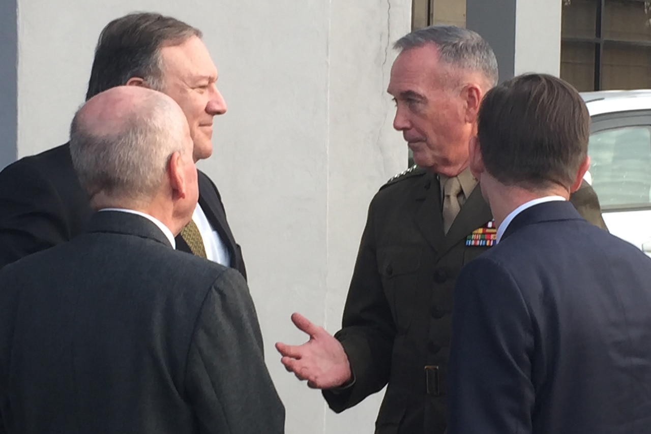 Secretary of State Mike Pompeo, left, speaks with Marine Corps Gen. Joe Dunford.