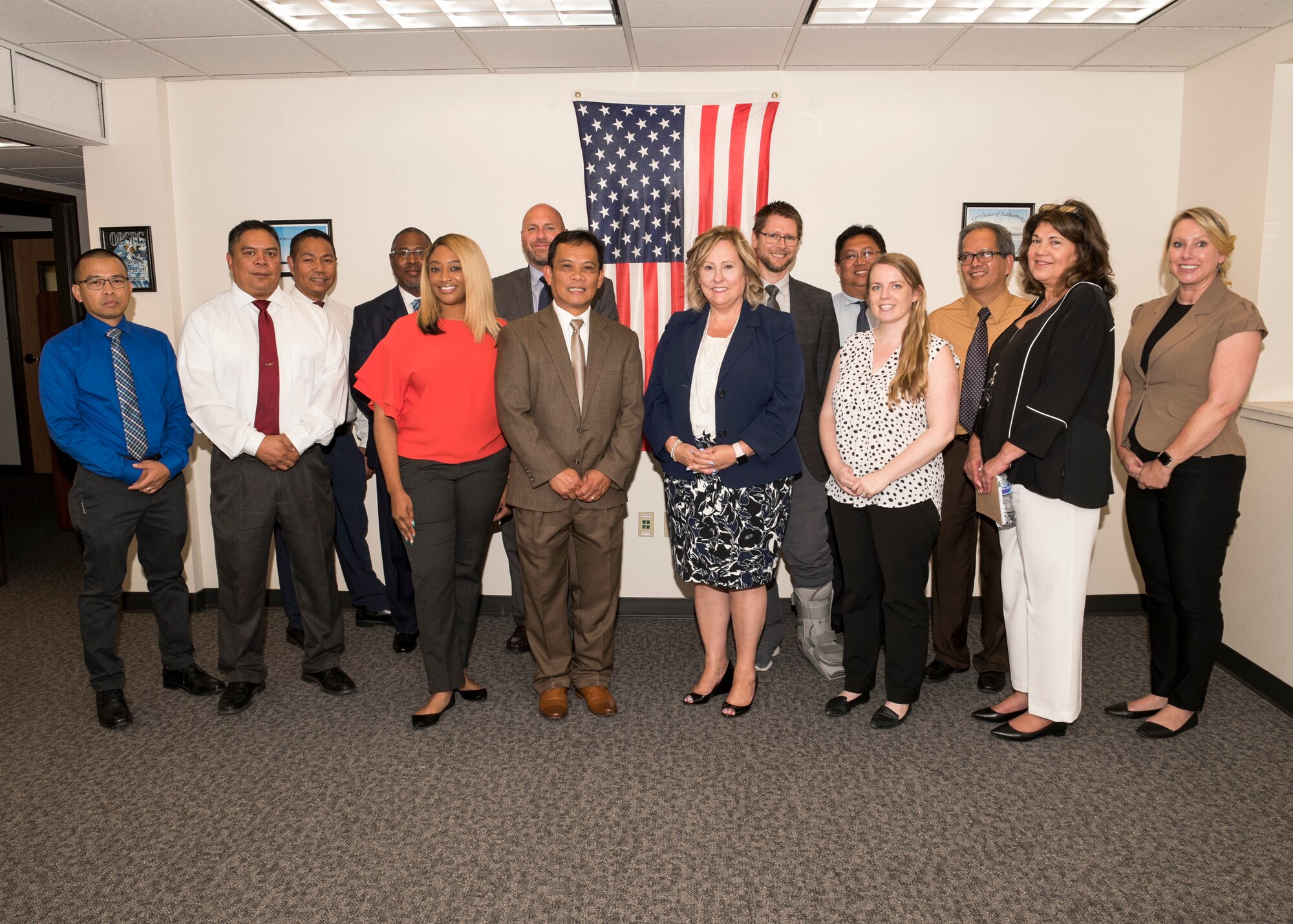 Ronna Garrett, Defense Civilian Personnel Advisory Service director, and Justin Kinnaman, DCPAS chief of staff, pose for a group photo with the DCPAS Wage and Salary Branch - Western Region office at Travis Air Force Base, Calif., Aug. 29, 2018. Garrett exercised her oversight responsibilities by visiting Travis and received feedback from DCPAS employees on a variety of topics. According to the DCPAS website, the organization is responsible for the development and delivery of civilian personnel policies and human resources solutions that stengthen mission readiness. (U.S. Air Force photo by Lan Kim)