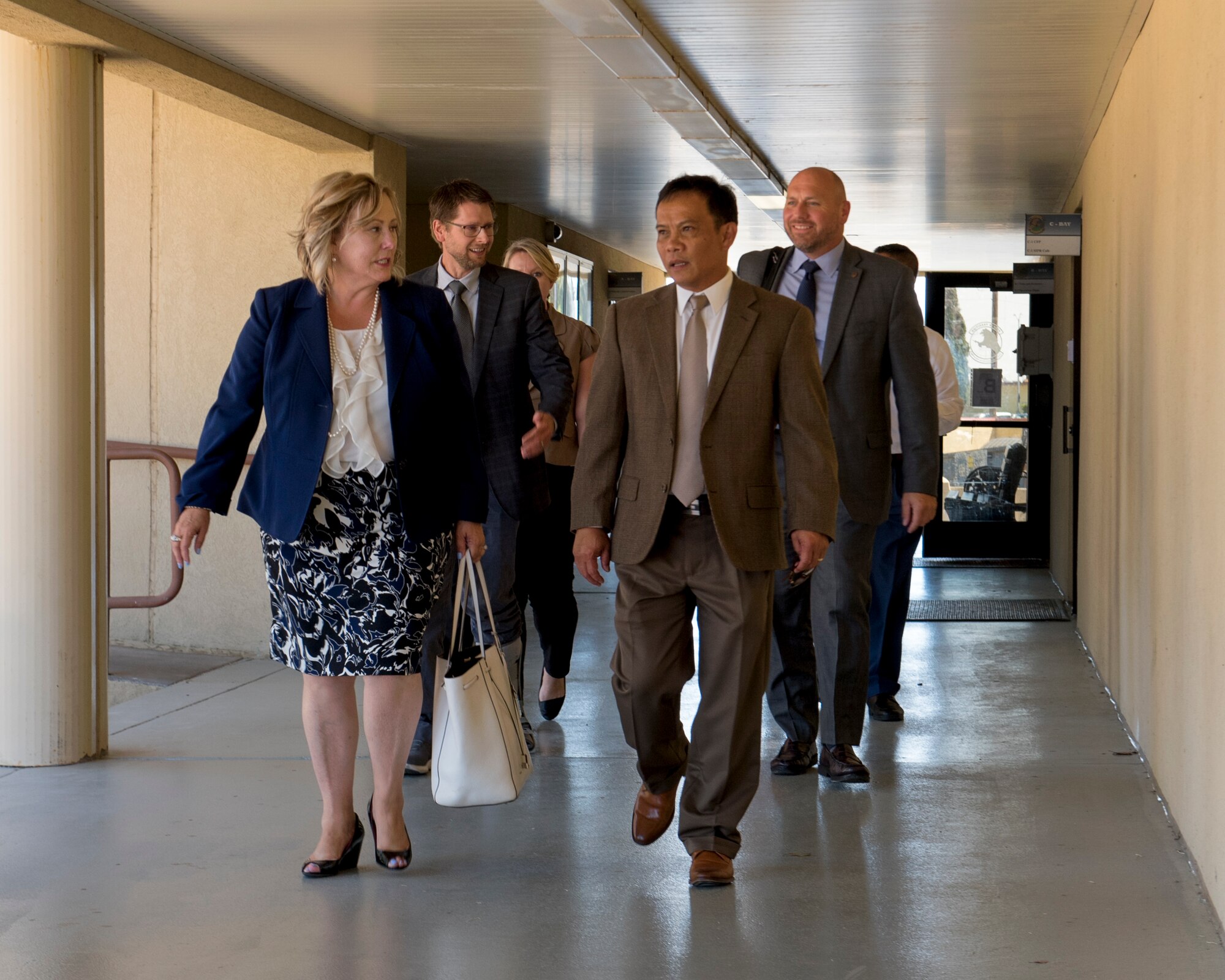 Ronna Garrett, Defense Civilian Personnel Advisory Service director, speaks with Jerry Dollente of the DCPAS Wage and Salary Branch - Western Region office at Travis Air Force Base, Calif., Aug. 29, 2018, during an office visit. Garrett exercised her oversight responsibilities by visiting Travis and received feedback from DCPAS employees on a variety of topics. According to the DCPAS website, the organization is responsible for the development and delivery of civilian personnel policies and human resources solutions that stengthen mission readiness. (U.S. Air Force photo by Lan Kim)