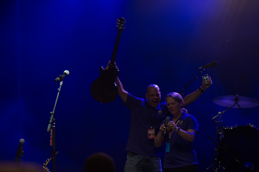 (From the left) Command Sgt. Maj. Eric Vidal, 733rd Mission Support Group command sergeant major, and Col. Jennifer Walkawicz, 733rd Mission Support Group commander, draw raffles during the End of Summer Music Festival at Joint Base Langley-Eustis, Virginia, Sep. 1, 2018.