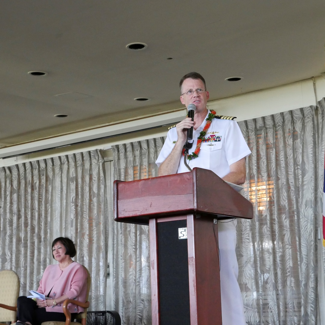 PHNSY & IMF Commanding Officer, Captain Gregory Burton (Center), speaking at the 2018 PHNSY & IMF Apprentice Program Graduation Friday, 17 August 2018, alongside keynote speaker, Congresswoman Colleen Hanabusa (Left).