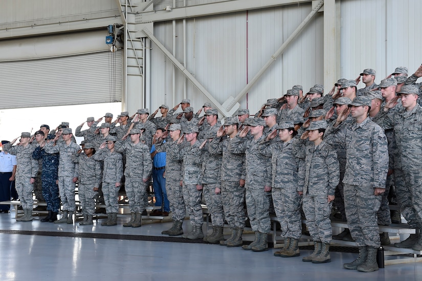 Members of Joint Base Charleston salute during the national anthem at a change of command ceremony Sept. 5, 2018, at Joint Base Charleston, S.C. During the ceremony, Col. Terrence Adams replaced Col. Jeff Nelson as 628th Air Base Wing commander and Joint Base Charleston commander. Joint Base Charleston is one of 12 Department of Defense joint bases and is host to over 60 DOD and federal agencies. The 628th ABW delivers installation support to over 90,000 Airmen, Sailors, Soldiers, Marines, Coast Guardsmen, civilians, dependents and retirees across four installations including the Air Base and Naval Weapons Station.