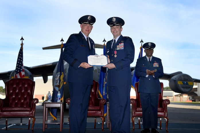 Col. Jeffrey Nelson, center, outgoing commander of the 628th Air Base Wing, receives the Legion of Merit medal from Maj. Gen. John Gordy II, left, U.S. Air Force Expeditionary Center commander, during a change of command ceremony Sept. 5, 2018, at Joint Base Charleston, S.C.