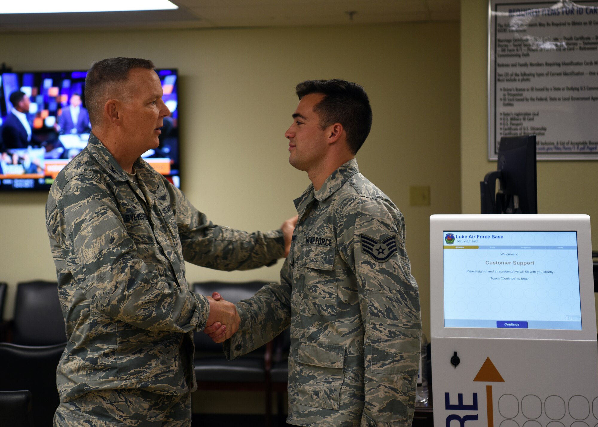 U.S. Air Force Staff Sgt. Cameron Moore, 56th Force Support Squadron customer service supervisor, receives a coin from U.S. Air Force Col. Robert Sylvester, 56th Mission Support Group commander, Aug. 29, 2018 at Luke Air Force Base, Ariz.