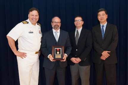 Dr. Timothy Coats, lead for Combatant Craft Division's Unmanned Maritime Mobility Group, receives the Capt. Harold E. Saunders Award for exemplary technical management at the Naval Surface Warfare Center, Carderock Division Honor Awards ceremony Aug. 28, 2018, in West Bethesda, Md. From left to right: Commanding Officer Capt. Mark Vandroff; Coats; Steve Ouimette, deputy head of the Naval Architecture and Engineering Department; and Dr. Paul Shang, acting technical director. (U.S. Navy photo by Nicholas Brezzell/Released)