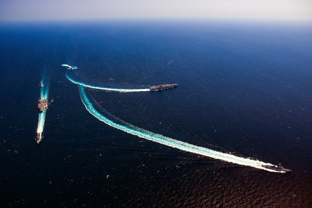 Navy ships traverse the open ocean.