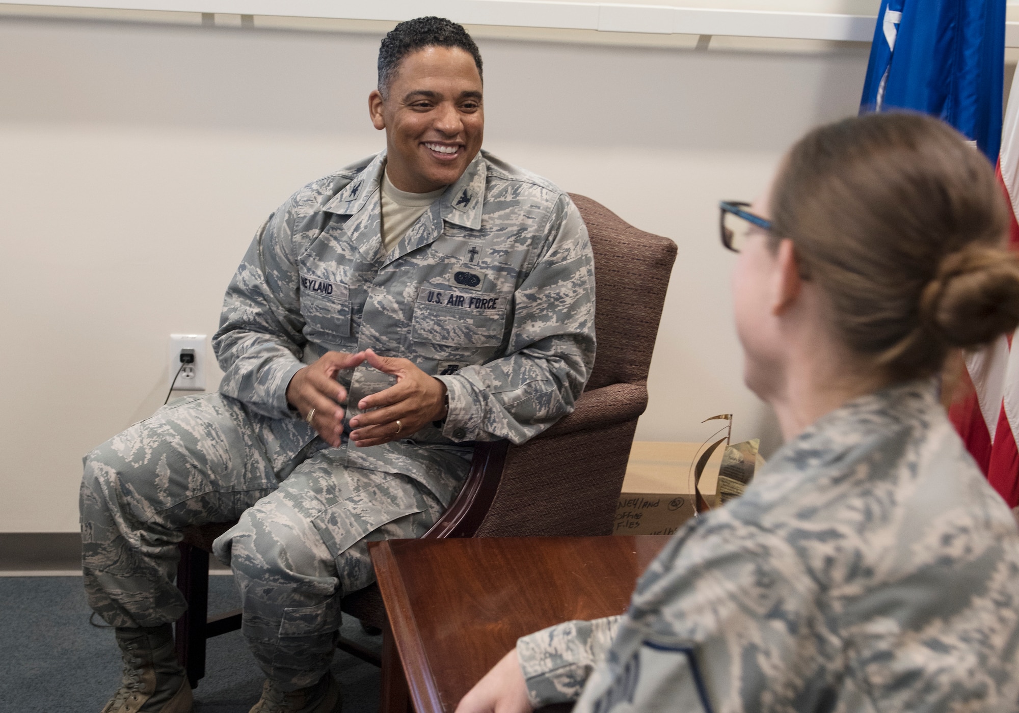 Chaplain (Col.) Shon Neyland, Pacific Air Forces Command Chaplain, speaks with Master Sgt. Kristen Allen, religious affairs, in his office at Headquarters PACAF, Joint Base Pearl Harbor-Hickam, Hawaii, Sept. 5, 2018.