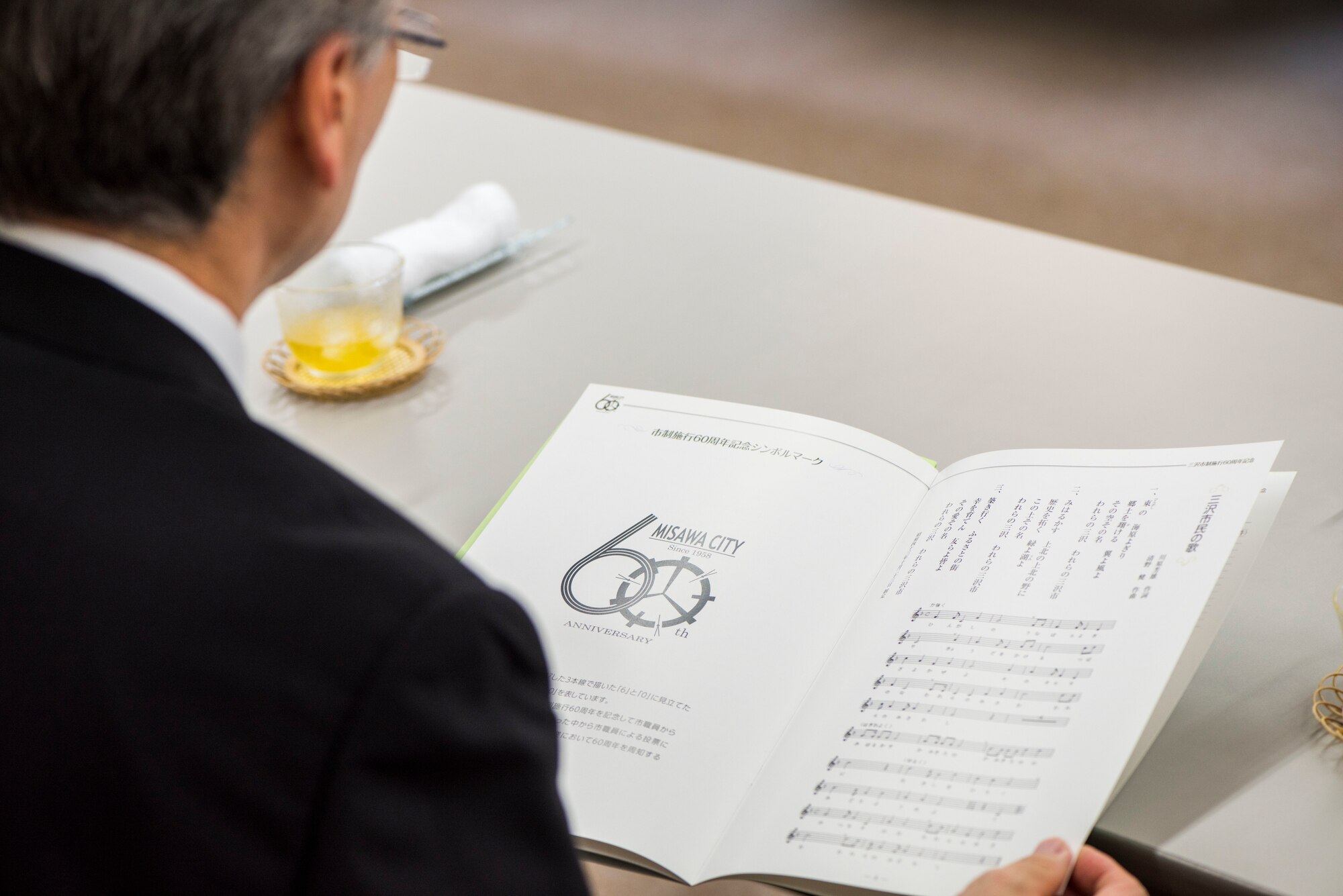 A Misawa City resident reads a brochure during a meeting at the Misawa City 60th anniversary celebration ceremony held at the Misawa International Center in Misawa City, Japan, Sept. 1, 2018. Misawa evolved from a village to a town throughout the years and is now recognized as a city. The city is home to an array of U.S. service members, Japan Air Self-Defense Force members and Japanese citizens. (U.S. Air Force photo by Airman 1st Class Collette Brooks)