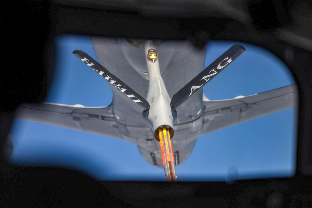 An aircraft crew conducts a midair refueling.